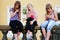 Teen girls calling on mobile phones in city street