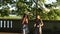 Teen girls girlfriends jump in the Park under a tree.