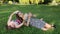 Teen girls girlfriends lying on the lawn taking pictures of himself on a mobile phone, selfie.