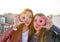 Teen girls portrait with donuts in eye having fun