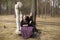 Teen girls sitting on the broken sculpture in the park. Nature.