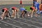 Teen Girls in Starting Blocks at High School Race
