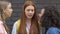 Teen girls teasing red hair student, calling names or insulting, peer pressure