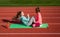 teen girls training on outdoor stadium with fitness mat, workout