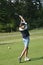 Teen golfer hits a golf ball  during a golf match