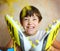 Teen handsome boy with brand new yellow football boots close up