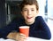 Teen handsome boy with cappuccino coffee paper