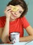 Teen handsome boy with tea cup and cheese slice