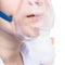 Teen inhales with face mask of nebulizer close up