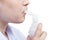 Teen inhales with mouthpiece of jet nebulizer