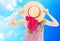 Teen lady hide face behind summer hat on blue sky background