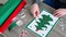 Teen making Christmas card from colored self-adhesive papers