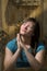 Teen prays by garden fence