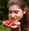 Teen pretty girl with handful of ripe strawberries