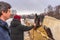 Teen redhead girl patting horse at ranch in snowy day. Winter weekend at farm, trip to countryside. Healthy lifestyle, active