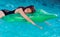 Teen relax in luxury swimming pool. Fashion crocodile leather and girl in water. Summer vacation and travel to ocean