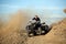 Teen riding quad ATV in hills