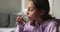 Teen school girl drinking fresh mineral water at home, closeup