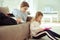Teen schoolchildren working with tablet at home during coronavirus quarantine