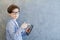 Teen schooler boy in eyeglasses holds tablet PC