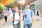 Teen schoolmates with backpacks and workbooks walking to college