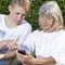 Teen and senior with smartphone