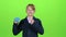 Teen shows and turns his head to the credit card on a green screen. Slow motion