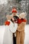 Teen siblings, their mother and black dog standing at winter park