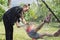 Teen sister girls and child having fun on hammock in the backyard garden