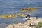 Teen sitting on rocks