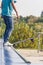 Teen with skateboard ready for a stunt on a half pipe ramp.