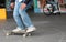 Teen skateboarder on skate board with disabled man