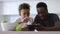 Teen son and dad use phone together. Spbi watch cartoons, play games. concept technology addicted