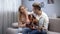 Teen student playing guitar and girlfriend hugging him, romantic love confession