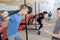 Teen training with weights at gym club with coach