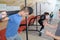 Teen training with weights at gym club with coach