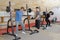 Teen training with weights at gym club with coach