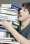 Teen Tries To Carry Unbalanced Stack Of Textbooks