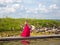 Teen walking along boardwalk graduation dress