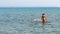 Teen walking out of sea water