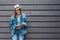 Teen woman read book outside wall