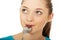 Teen woman with spoon in mouth.