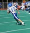 Teen Youth Football Player Running with the Ball