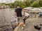 Teenage anglers netting a pike they have just hooked from the River Bure in Wroxham, Norfolk, UK