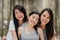 Teenage Asian female happy smiling to camera, Group of young Asian friends camping or picnic together in forest. Women do