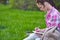 Teenage asian girl student writing in notebook in park. Preparation for exams at college or university