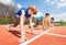 Teenage athletes preparing to start running