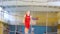 A teenage basketball player is training in the school sports hall.