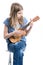 Teenage, blond girl in blue T-shirt is sitting and playing concert on ukulele instrument