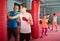 Teenage boxer with coach practicing